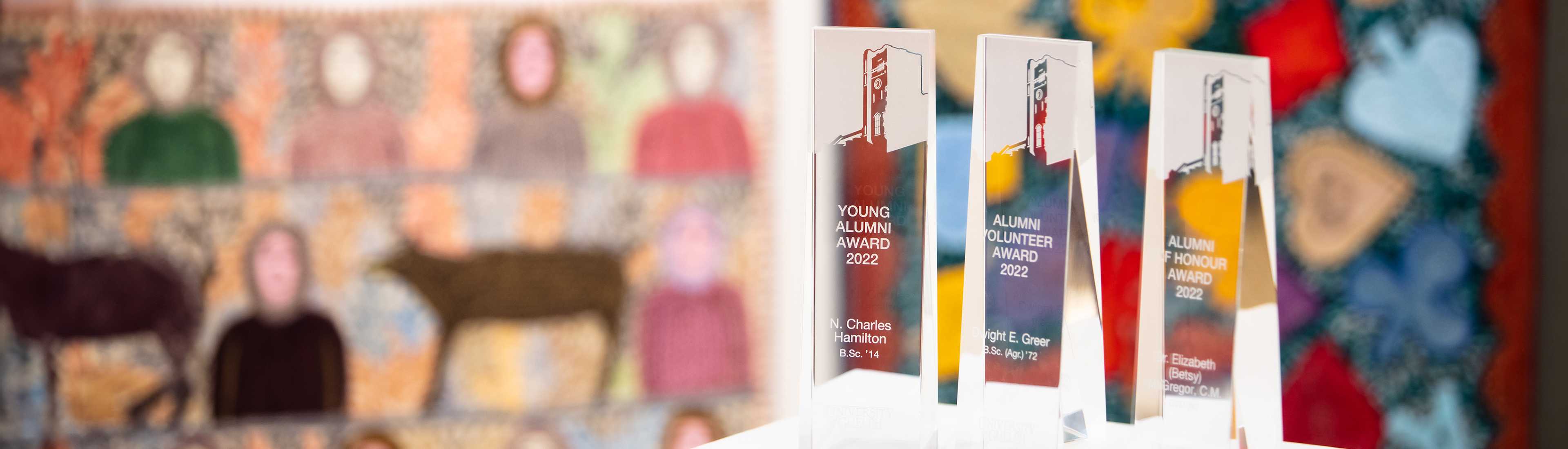 University of Guelph Awards of Excellence trophies 2022 with colorful artwork background